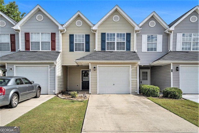 view of property featuring a garage and a front yard