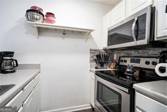 kitchen featuring stainless steel appliances, decorative backsplash, and white cabinetry