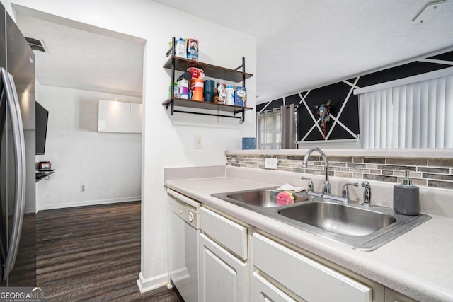 kitchen featuring stainless steel fridge, tasteful backsplash, dark hardwood / wood-style flooring, white dishwasher, and sink