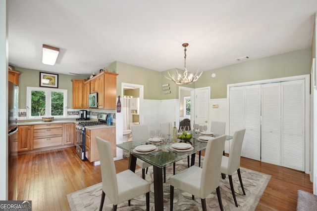 dining room with a chandelier and light hardwood / wood-style floors