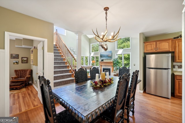 dining area featuring an inviting chandelier and light hardwood / wood-style flooring