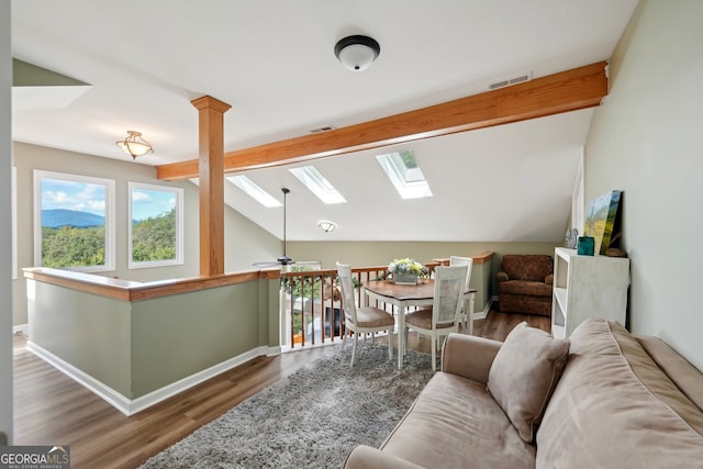 living room featuring vaulted ceiling with beams, ceiling fan, and dark hardwood / wood-style flooring