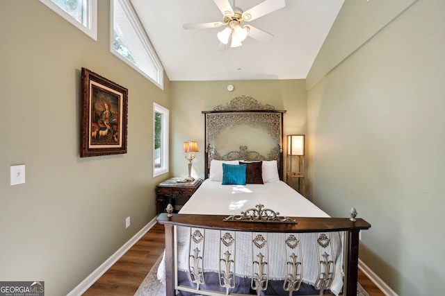 bedroom with multiple windows, vaulted ceiling, and hardwood / wood-style floors