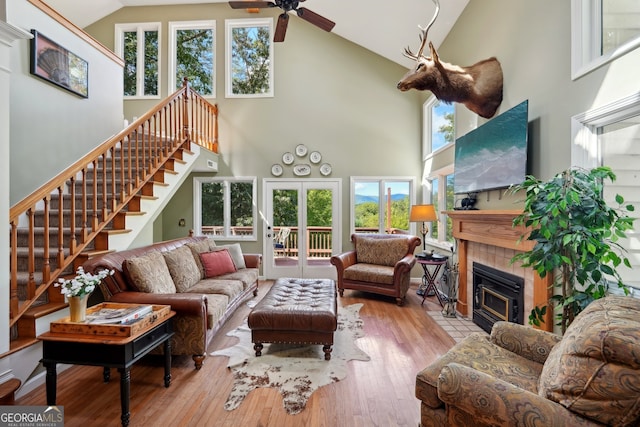 living room with high vaulted ceiling, light hardwood / wood-style floors, and plenty of natural light