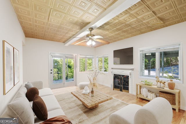 living room with ceiling fan, plenty of natural light, and hardwood / wood-style floors