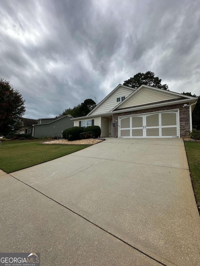 view of front of house with a front yard and a garage