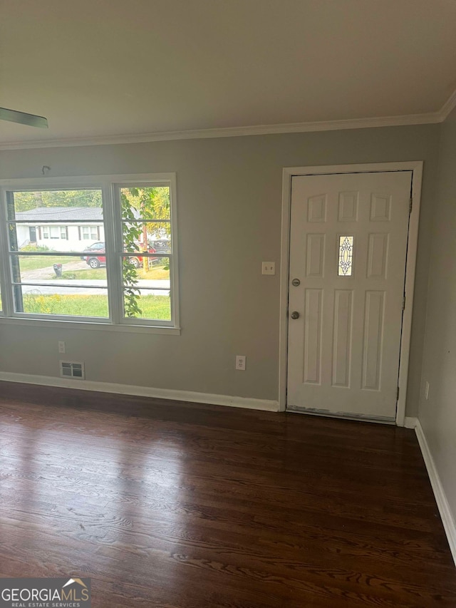 entrance foyer with dark hardwood / wood-style floors and ornamental molding