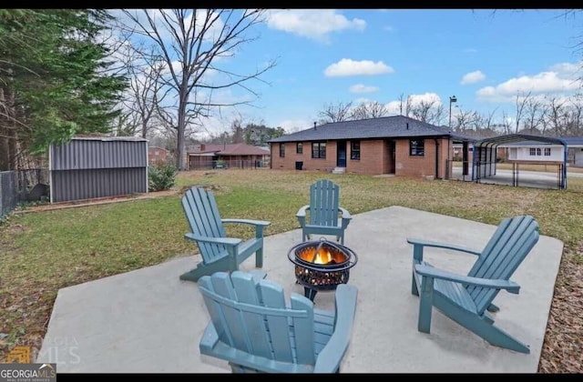 view of patio / terrace featuring a shed and an outdoor fire pit