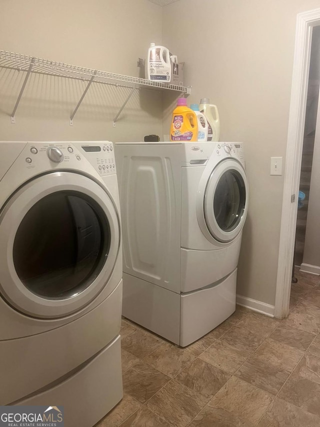 3364 Joseph Dr NW, Acworth, GA 30101 - laundry room featuring washing machine and dryer, baseboards, and light stone finish flooring