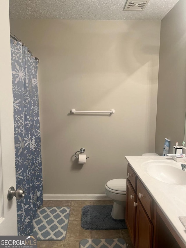 3364 Joseph Dr NW, Acworth, GA 30101 - bathroom with vanity, toilet, tile patterned floors, a textured ceiling, and baseboards