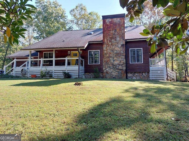 back of house featuring a lawn