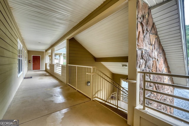 hallway featuring lofted ceiling