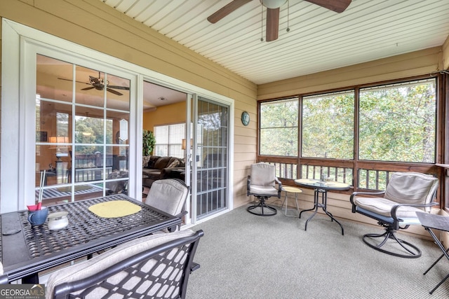 sunroom / solarium featuring ceiling fan