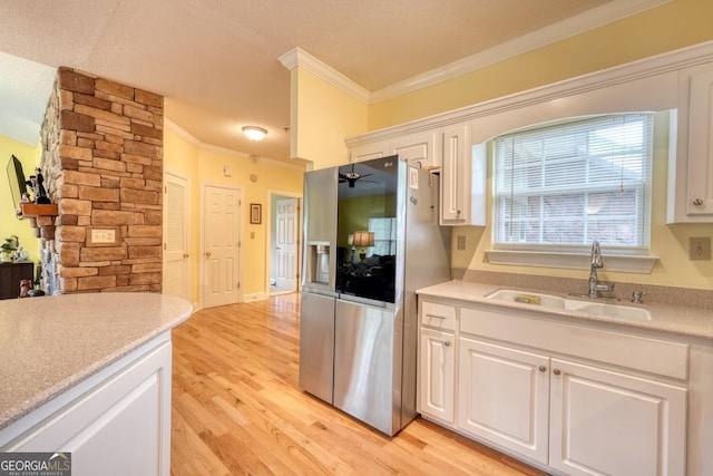 kitchen with white cabinets, light wood-type flooring, ceiling fan, stainless steel refrigerator with ice dispenser, and sink