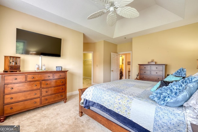 carpeted bedroom featuring ceiling fan, a closet, and a walk in closet