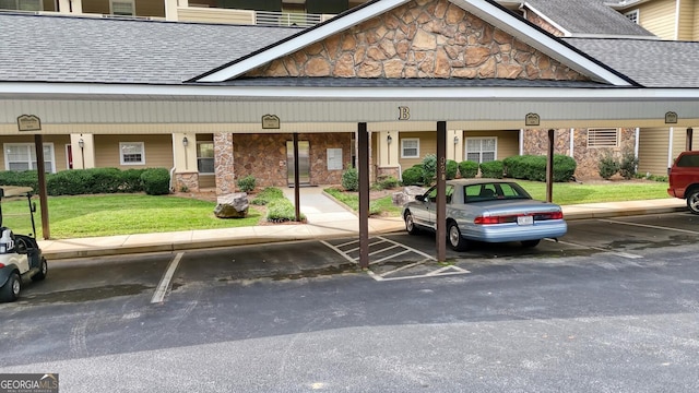 view of vehicle parking with a lawn