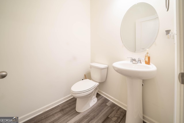 bathroom featuring hardwood / wood-style floors and toilet