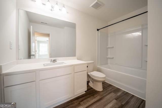 full bathroom featuring vanity, wood-type flooring,  shower combination, and toilet