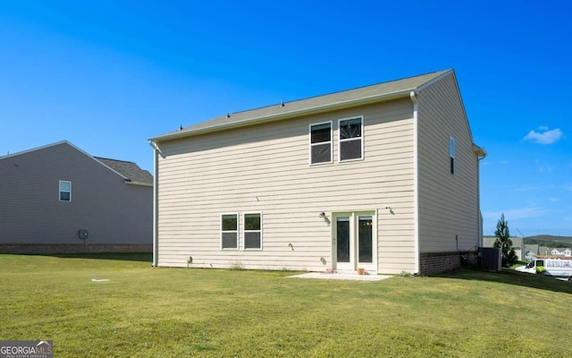 rear view of property with a lawn and central AC