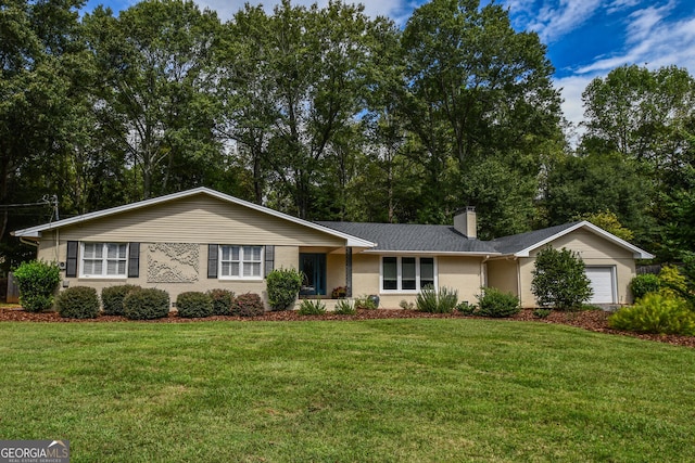 ranch-style house featuring a garage and a front lawn