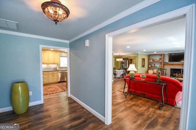 corridor featuring crown molding, a chandelier, and dark hardwood / wood-style flooring