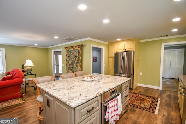 kitchen with dark hardwood / wood-style floors, stainless steel refrigerator, a breakfast bar area, and a center island