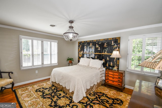 bedroom featuring multiple windows, crown molding, a chandelier, and wood-type flooring