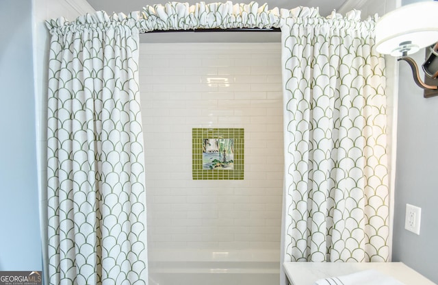 bathroom with shower / bath combo and vanity