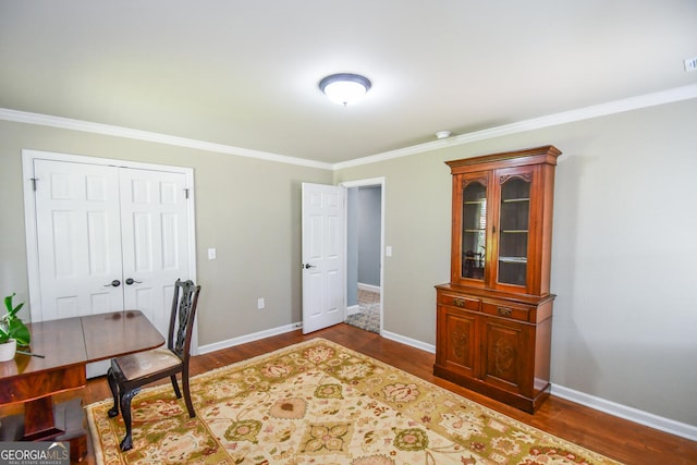 home office featuring ornamental molding and dark hardwood / wood-style flooring