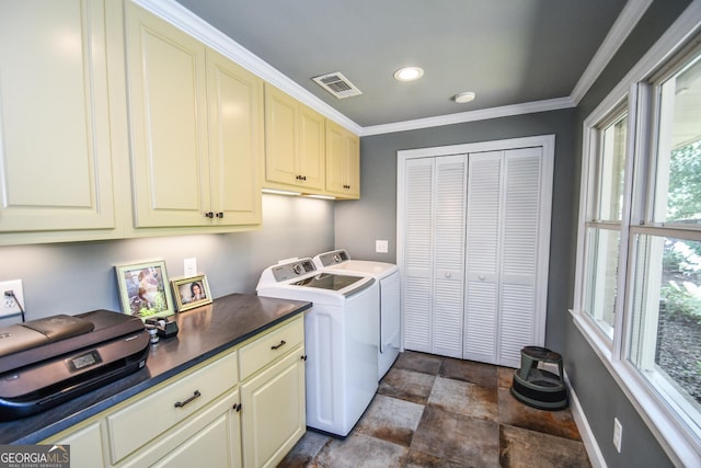 laundry area featuring crown molding, cabinets, plenty of natural light, and washing machine and clothes dryer