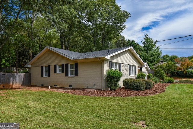 view of side of property featuring a yard