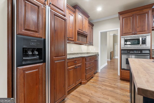 kitchen with stainless steel appliances, light hardwood / wood-style flooring, and ornamental molding