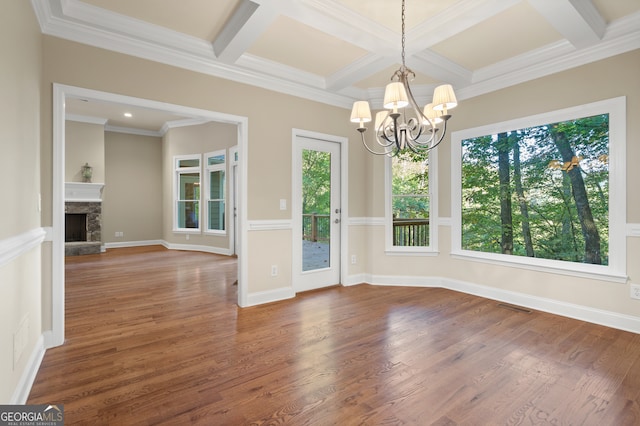 unfurnished dining area with dark hardwood / wood-style flooring, beam ceiling, a chandelier, and coffered ceiling