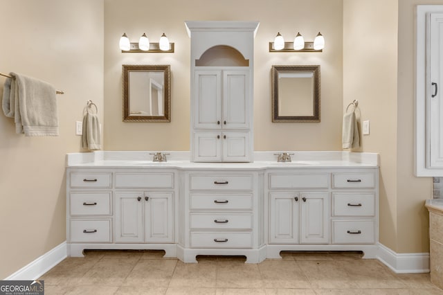 bathroom featuring tile patterned flooring and vanity