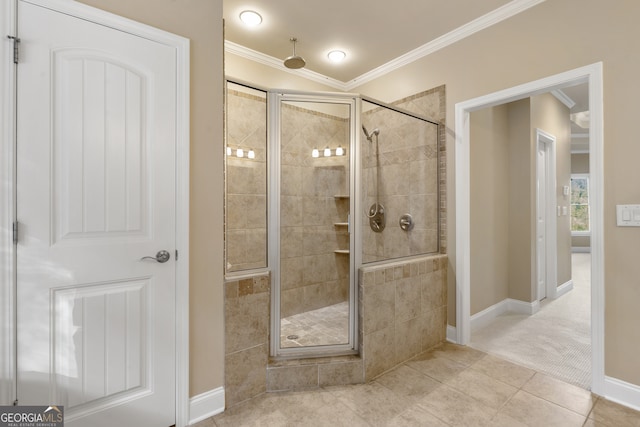 bathroom featuring tile patterned flooring, ornamental molding, and a shower with shower door