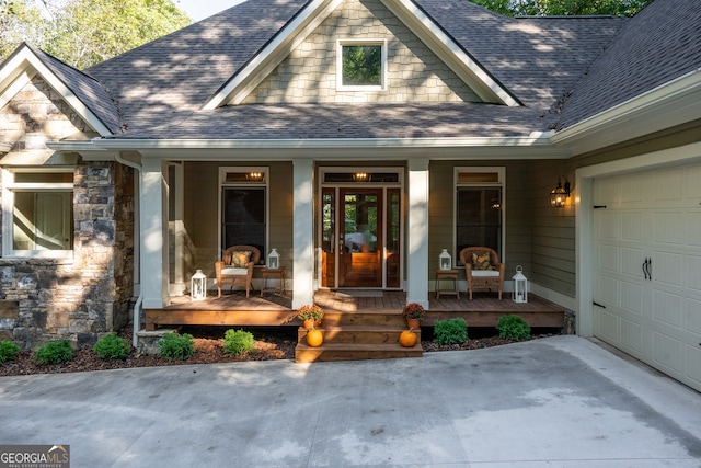 doorway to property with a garage and a porch