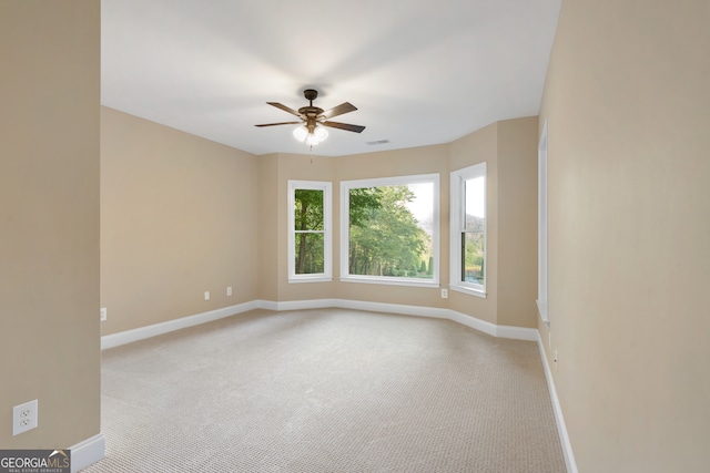 carpeted empty room with ceiling fan