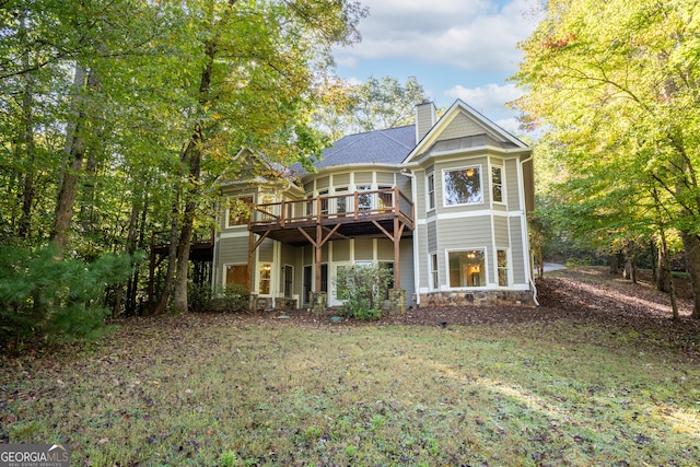 view of front of house featuring a front yard and a wooden deck