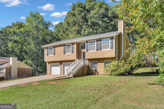 split foyer home featuring a front lawn and a garage