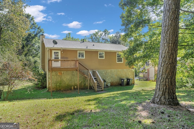 rear view of property featuring a lawn