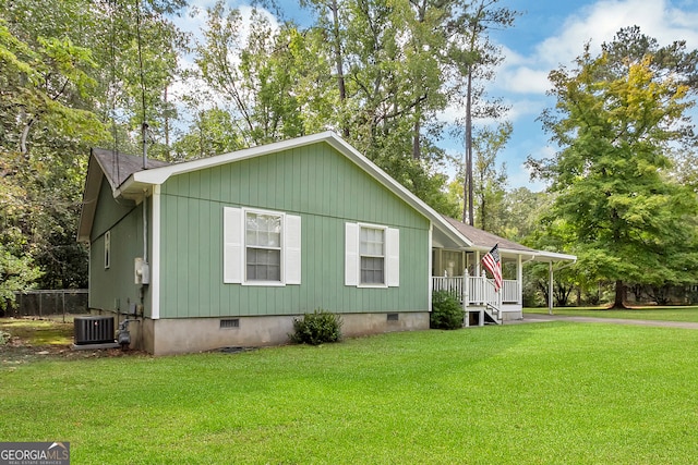 manufactured / mobile home featuring a front lawn, covered porch, and central air condition unit