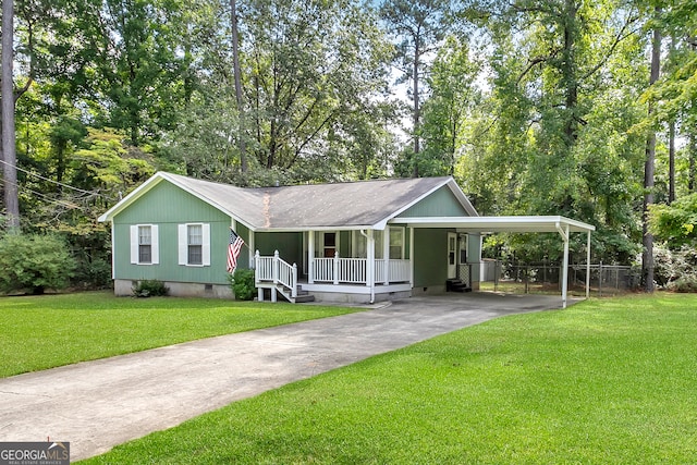 view of front of property with a front yard, covered porch, and a carport