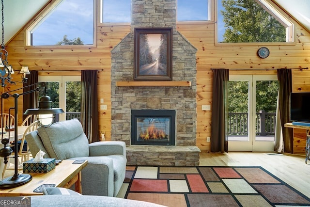 living room with high vaulted ceiling and a healthy amount of sunlight