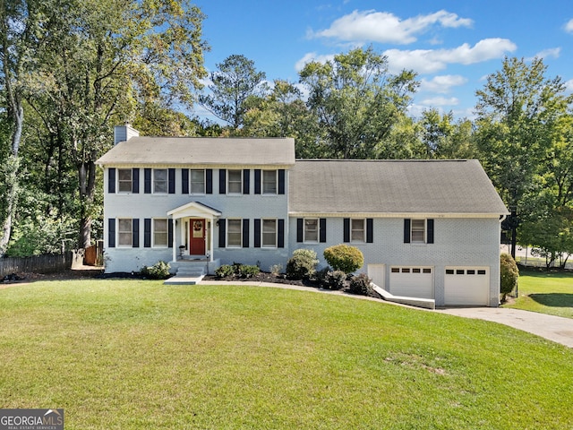 colonial house with a garage and a front yard