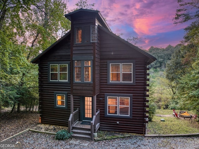 view of back house at dusk