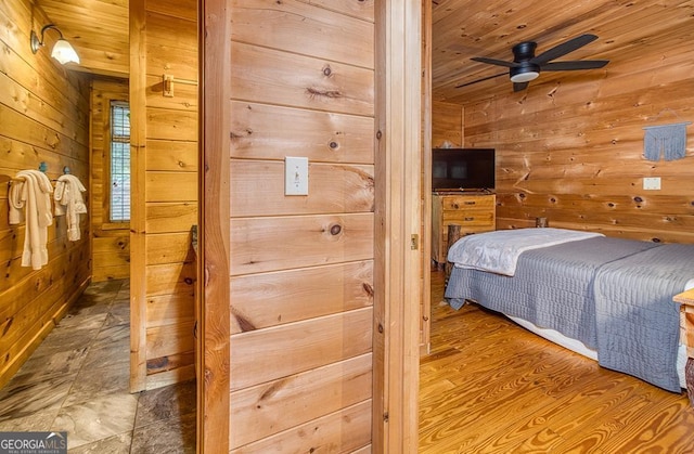 bedroom featuring wood walls, ceiling fan, wooden ceiling, and hardwood / wood-style floors