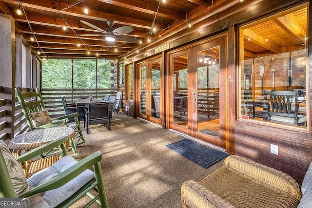 sunroom with ceiling fan, wood ceiling, and beam ceiling