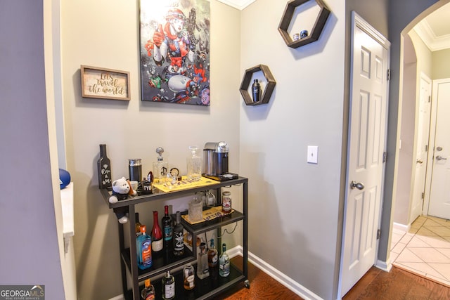 corridor with dark hardwood / wood-style floors and ornamental molding