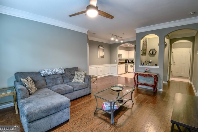 living room featuring ceiling fan, ornamental molding, and dark hardwood / wood-style flooring