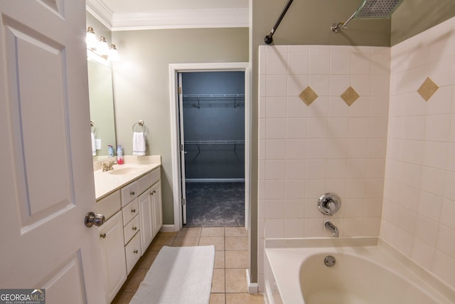 bathroom featuring crown molding, tiled shower / bath, vanity, and tile patterned floors